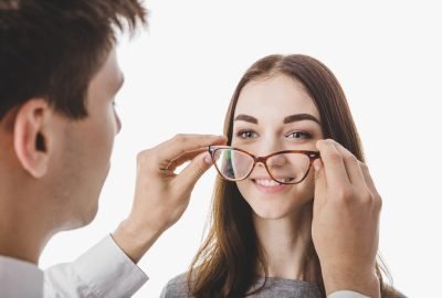 doctor-putting-glasses-woman