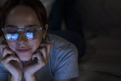 front-view-woman-looking-laptop-night